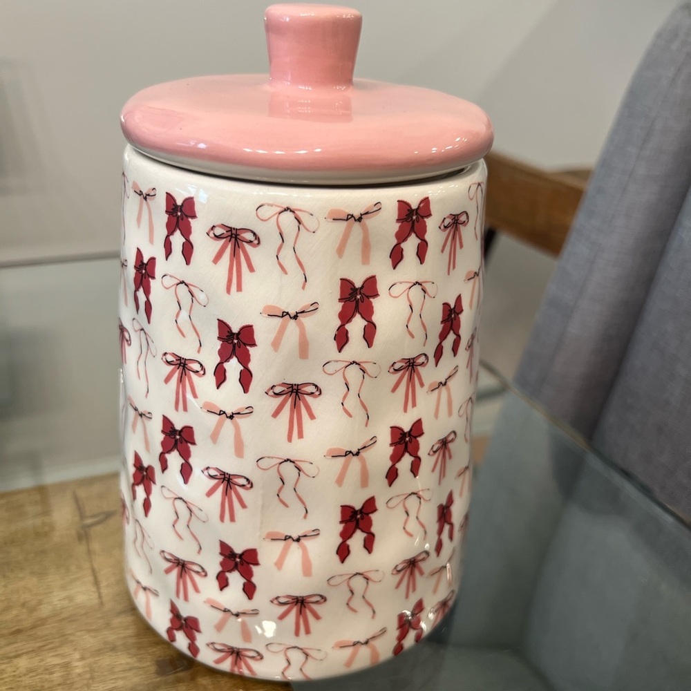 canister jar with a pink bow design, from the brand 10 Strawberry Stree